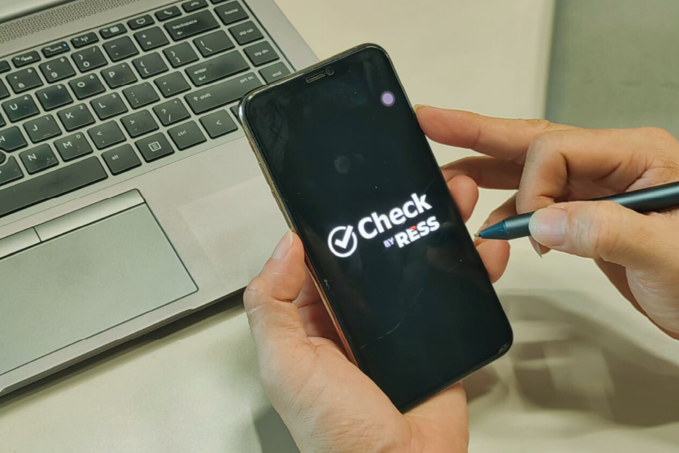 A user launching the Check by RESS mobile app, designed for quick reporting, verification, and streamlined security communication.